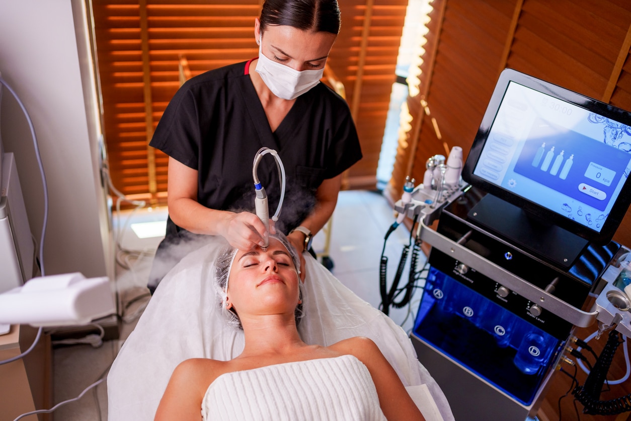 Cosmetologist making mesotherapy injection with dermapen on face for rejuvenation on the spa center